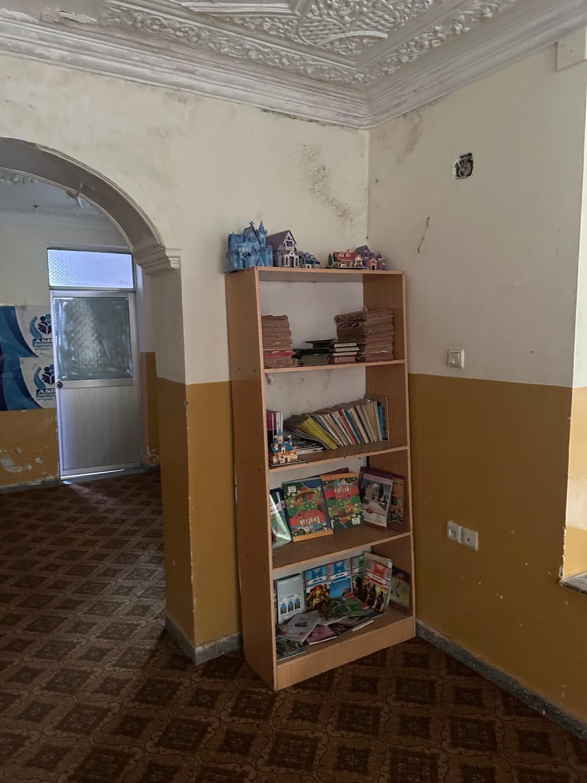 Bookshelf of learning materials at a partner education space