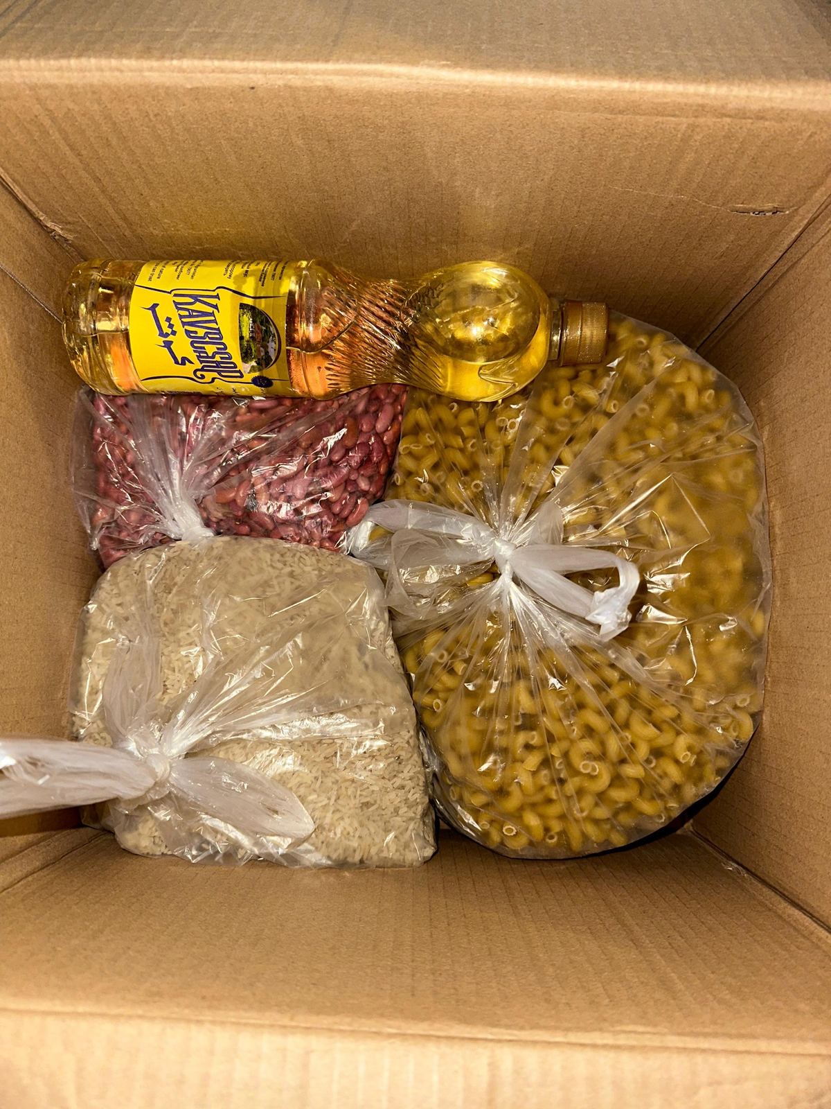 Emergency food parcel contents — rice, oil, beans and pasta