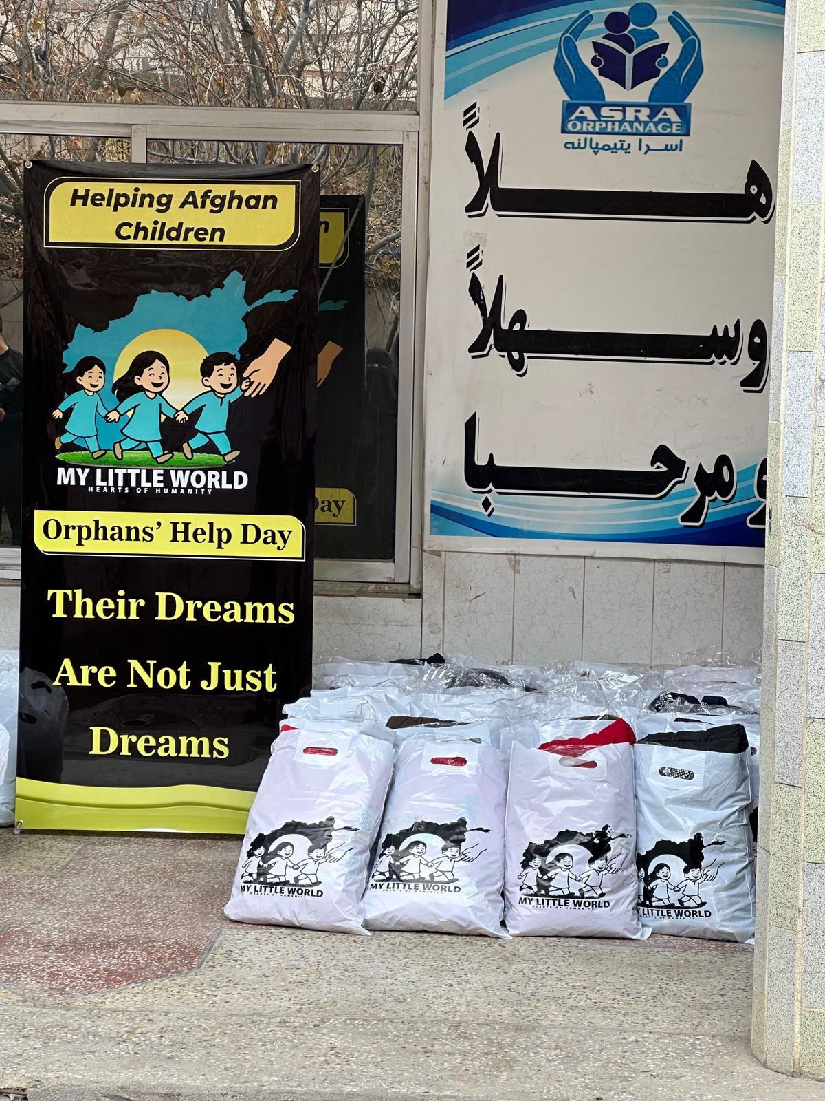 Helping Afghan Children campaign banner and prepared relief bags